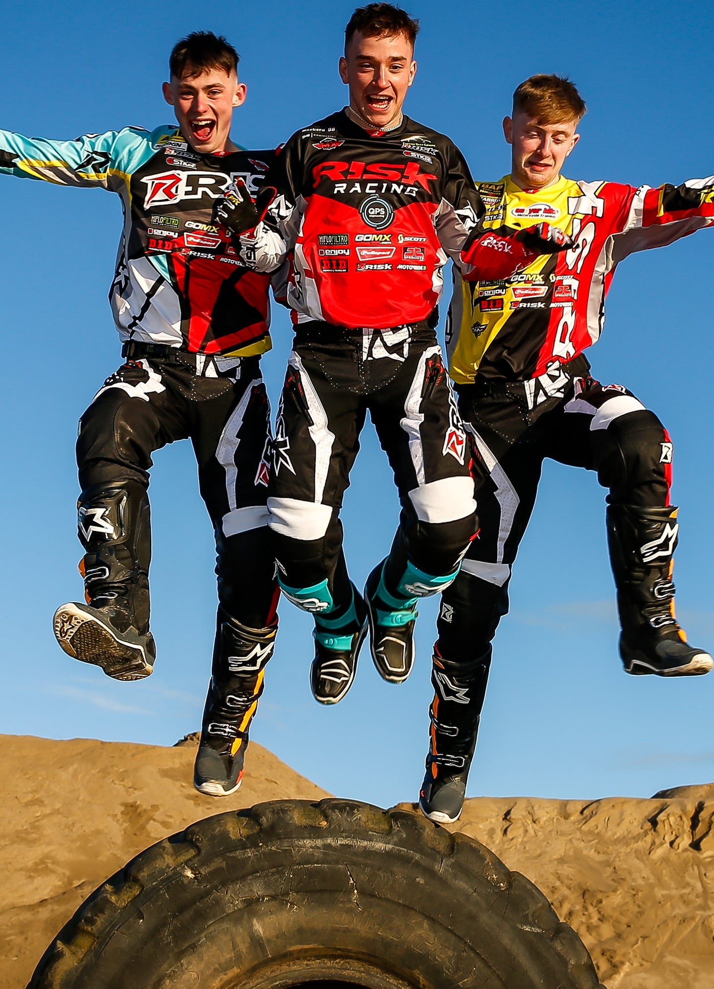 3 males jumping in mid air. all of them wearing a different combination of Risk Racing's Mix N Match V2 MX Gear. 3 different jerseys that match a single pair of pants.