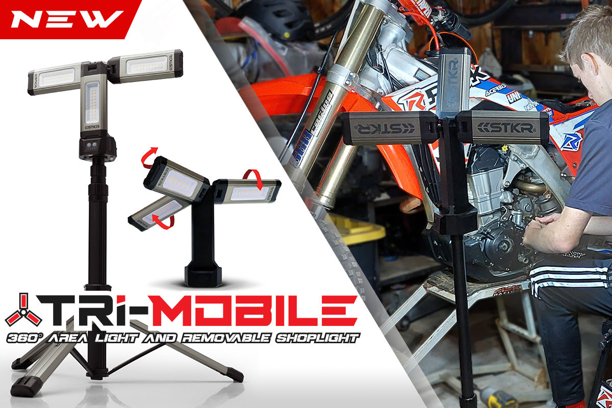 Tri-Mobile homepage banner featuring 2 studio product shots and 1 lifestyle image. The area work light is shown on a tripod lighting up a male and his dirt bike that's he's working on in a garage setting. Arrows show off rotatable light panels.
