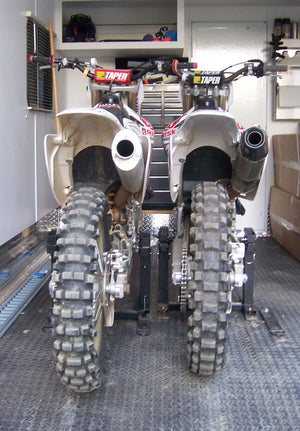 Two Honda mx bikes loaded into an RV with the Lock-N-Load Moto Transport System. No messy straps needed. Rear View