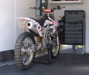 Honda mx bike loaded into an RV with the Lock-N-Load Moto Transport System. No messy straps needed